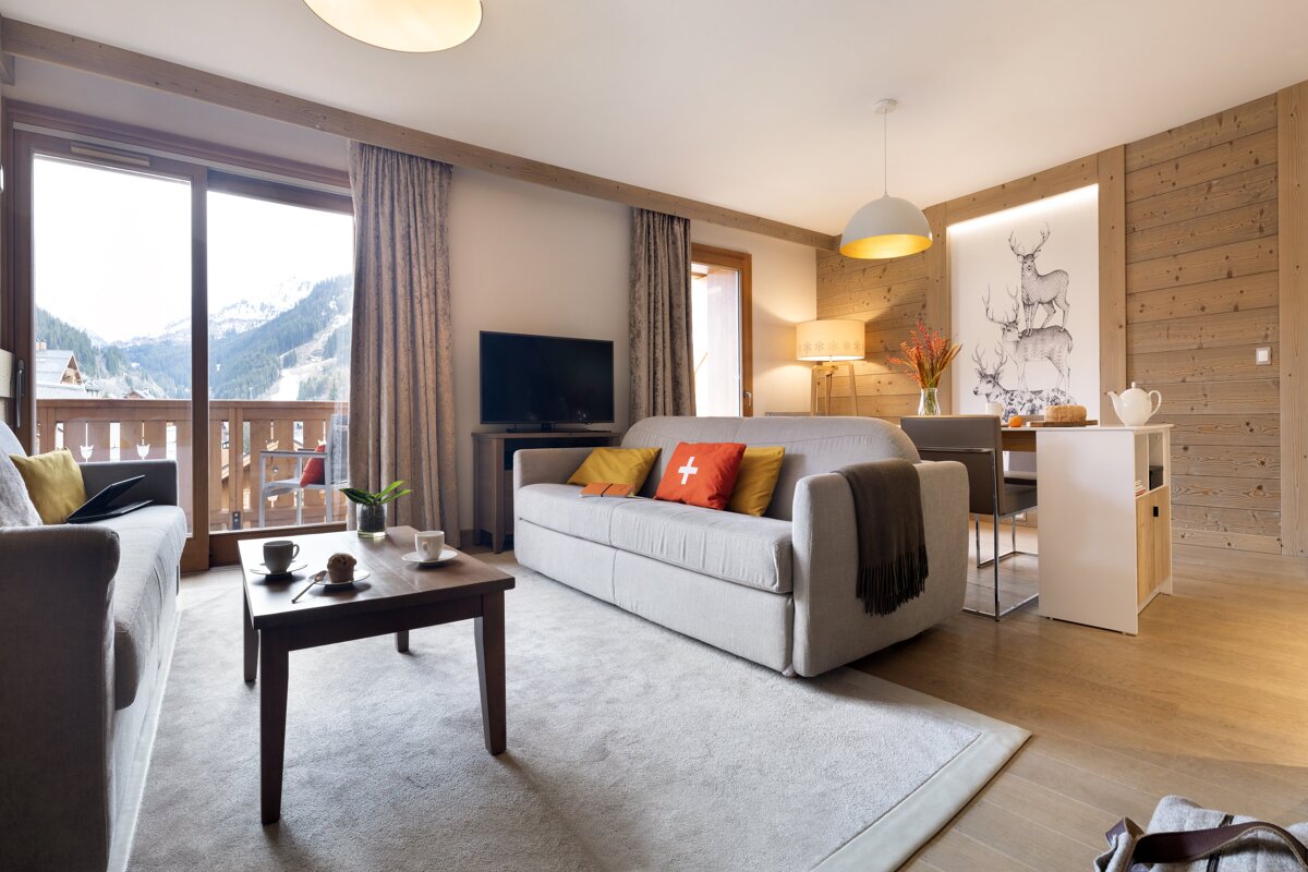 A living room with a couch that has a cross on it