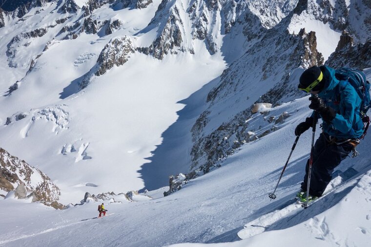 two skiers on a steep face off-piste