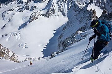 two skiers on a steep face off-piste