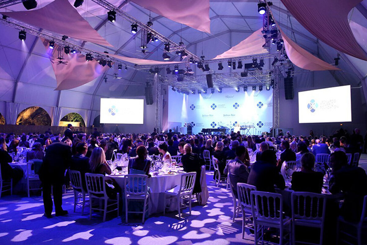 a room filled with tables for a gala dinner in saint tropez