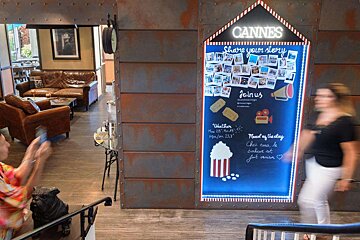 A sign that says cannes share your story join us