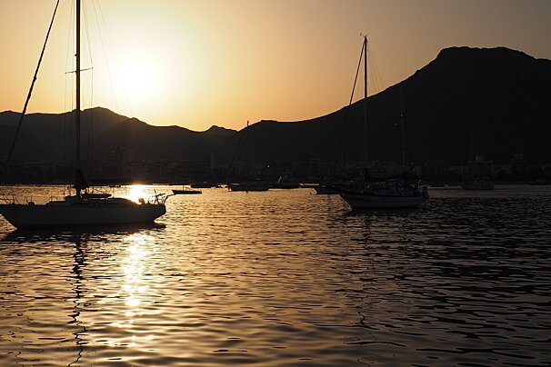 sunset behind two yachts in mallorca