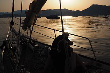 the bow of a boat at sunset