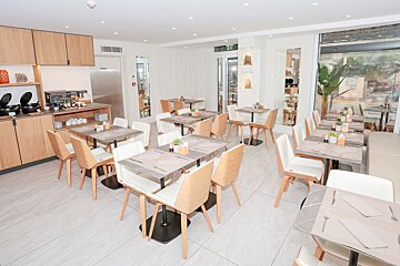 A dining room with tables and chairs and a sign that says exit