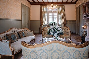 A living room filled with furniture and a vase of flowers