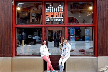two women sat at the entrance to an office in Les Arcs