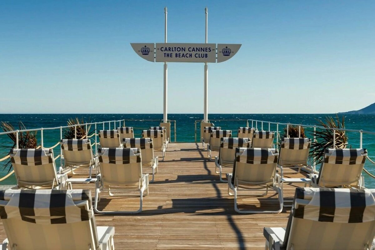 The carlton cannes beach club is located on the shore of the ocean