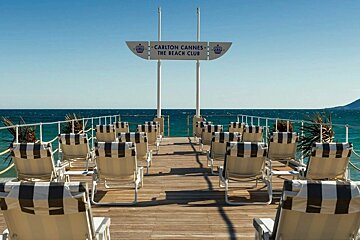 The carlton cannes beach club is located on the shore of the ocean