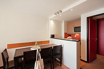A dining room table with a bottle of water on it