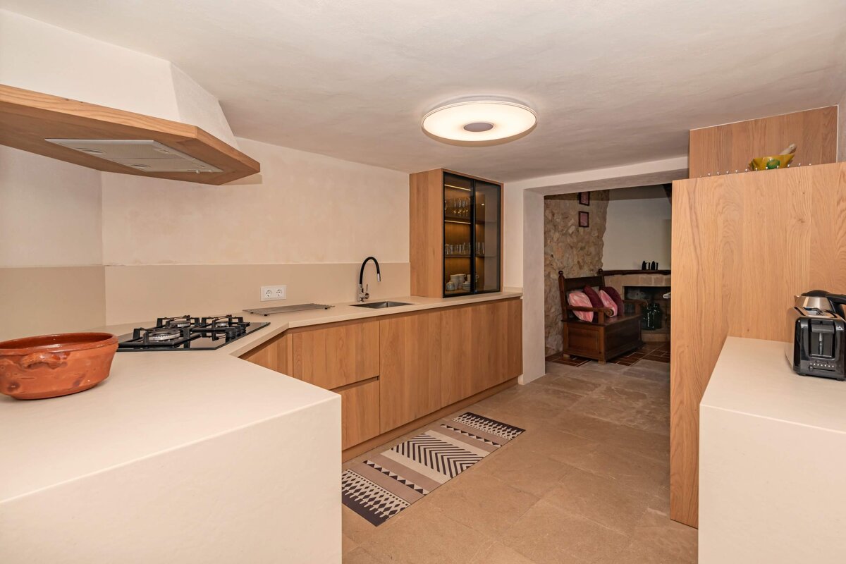 A kitchen with wooden cabinets and a bosch toaster