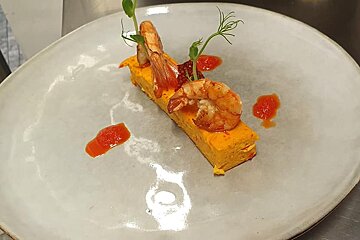 A plate of food with shrimp and sauce on it