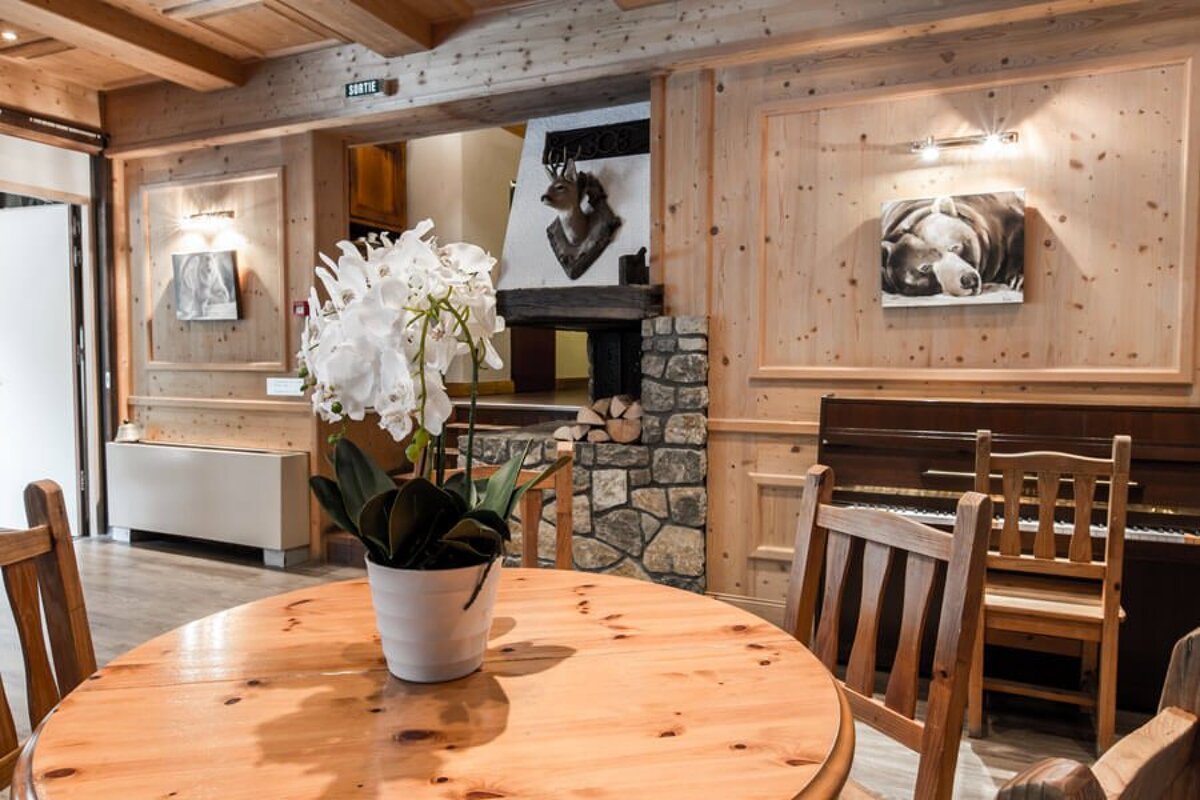 A wooden table with a vase of flowers on it