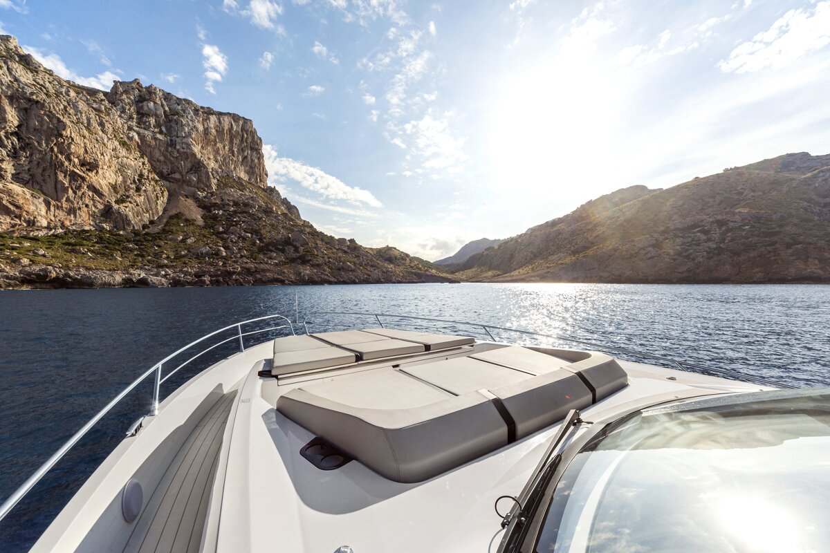 A boat in the water with mountains in the background