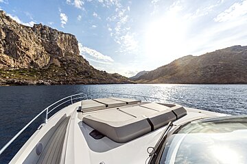 A boat in the water with mountains in the background