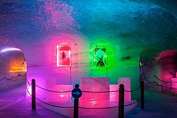 a glacier cave with coloured lights