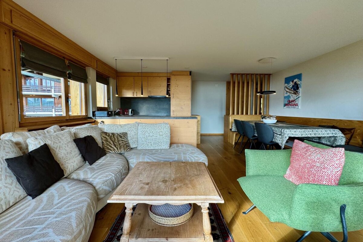 A living room with a couch and a green chair