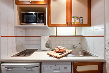 A small kitchen with a microwave and a dishwasher