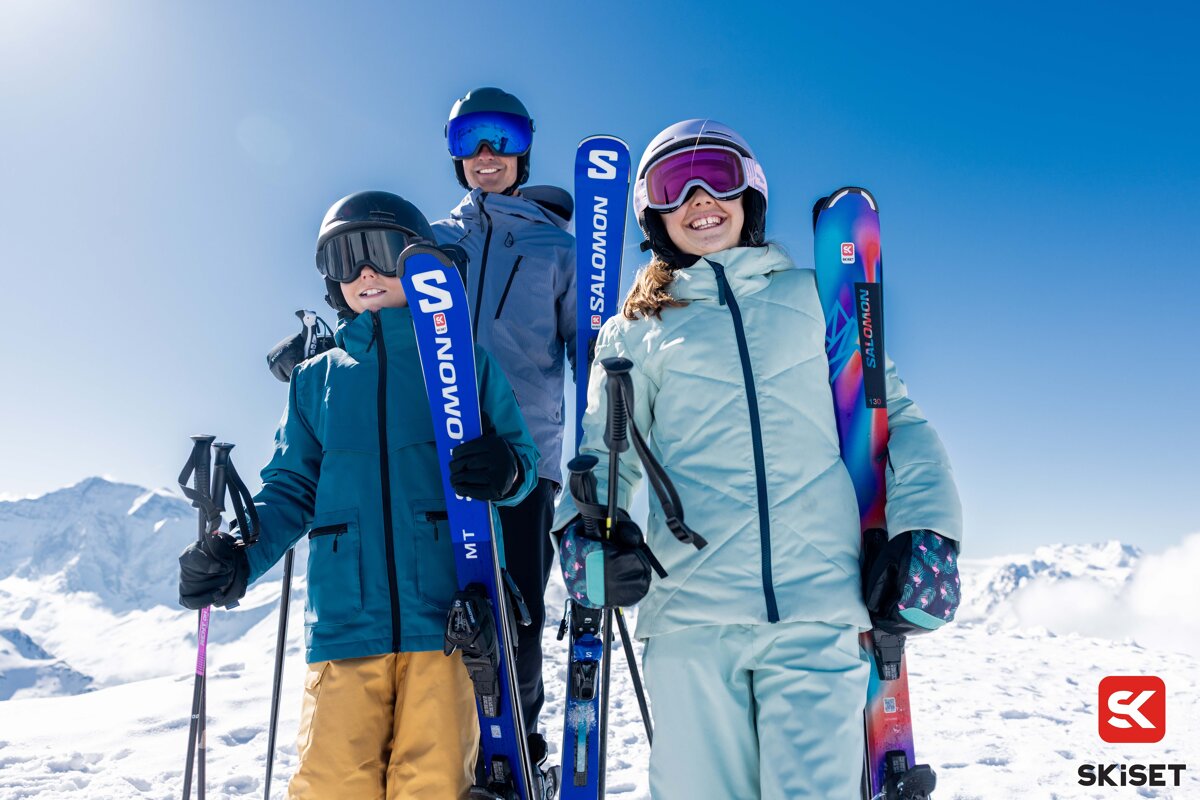 A group of people holding skis that say salomon on them