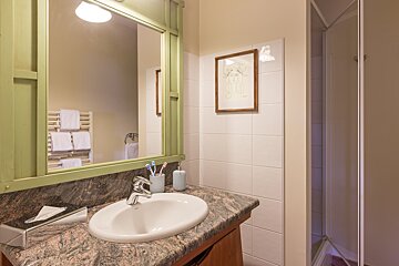 A bathroom with a sink and a picture on the wall