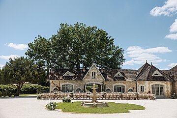 A large stone building with a fountain in front of it