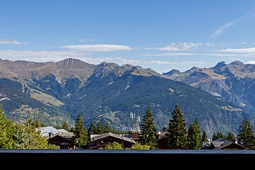 A view of a mountain range with houses in the foreground