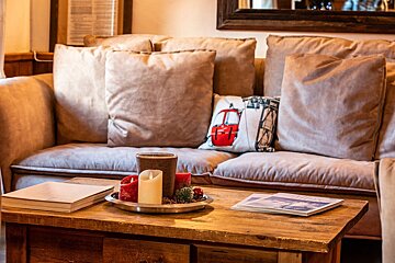 A couch with a pillow that has a red car on it