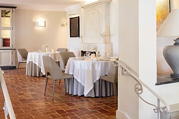 A dining room with white tables and chairs