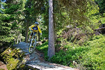 a mountain biker riding over a rock