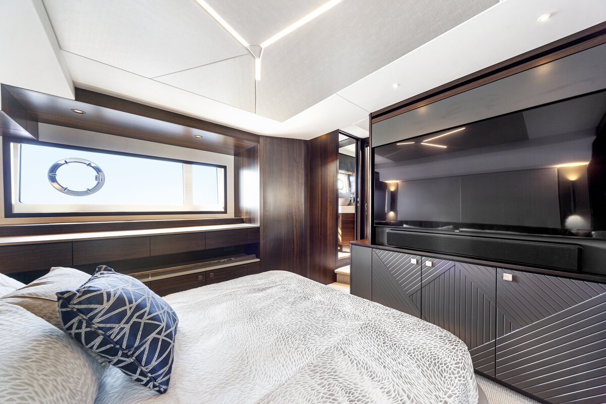 A bedroom with a large tv on the wall