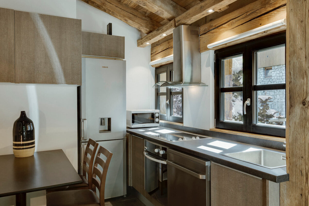 A kitchen with a fridge that says beko on it