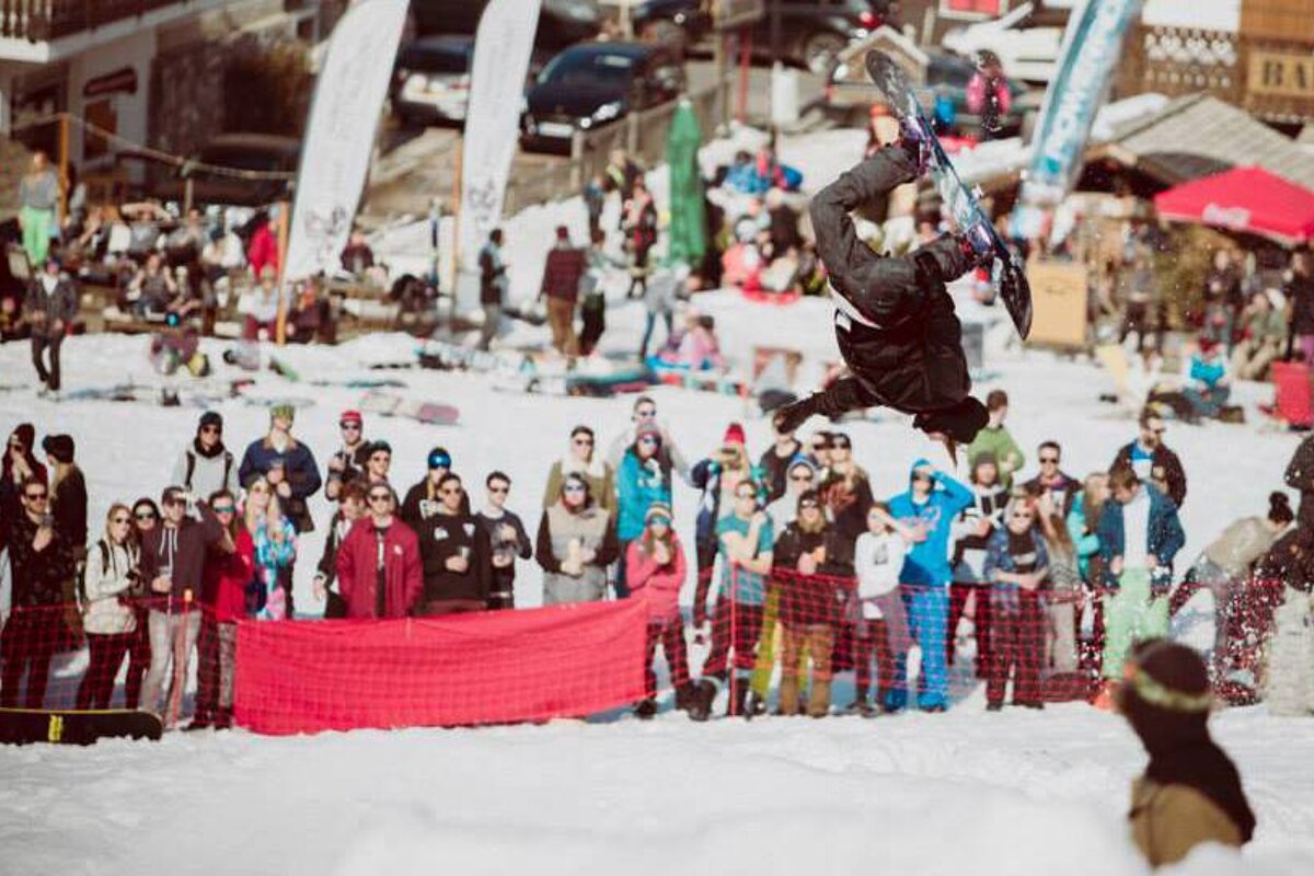 a snowboarder upside down in the air