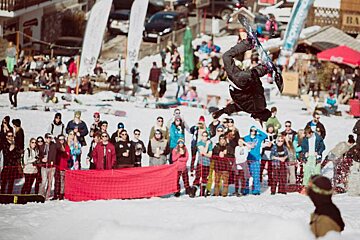 a snowboarder upside down in the air