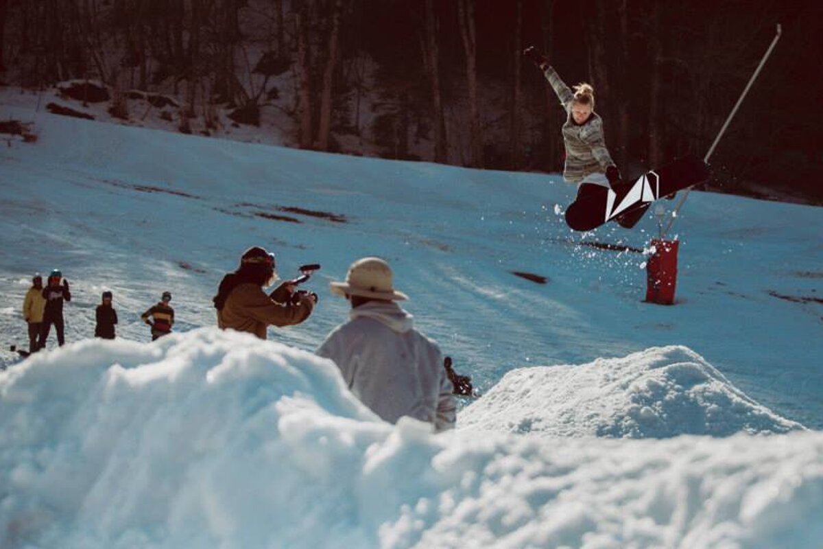 a female snowboarder jumping in the air