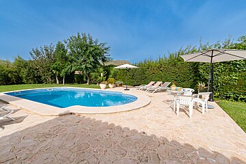 A swimming pool with chairs and umbrellas around it