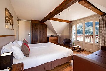 A hotel room with two beds and a couch