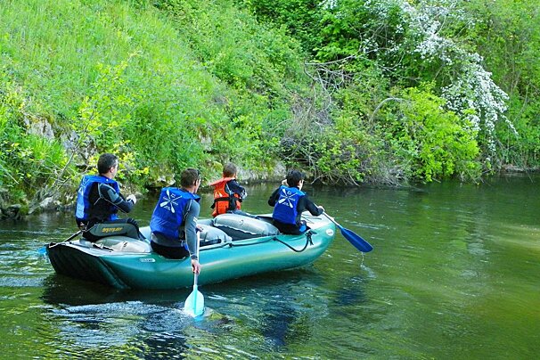 four people in a canoe/raft on the dordogne