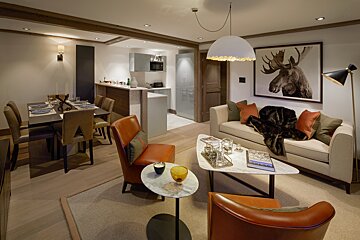 A living room with a moose painting on the wall