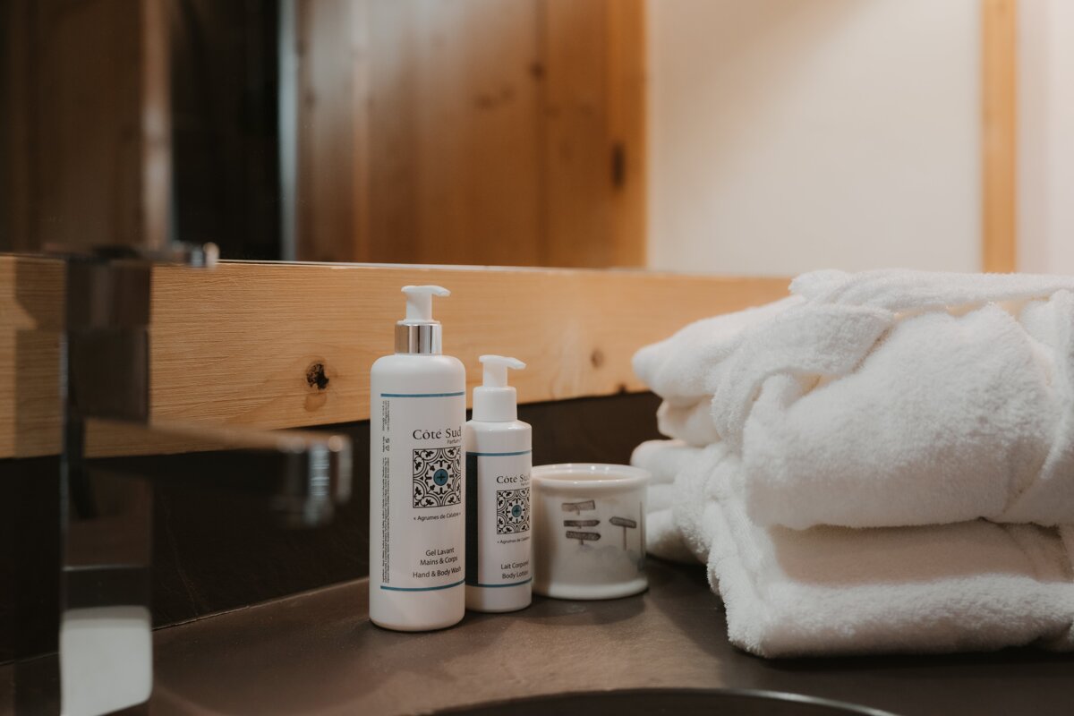 A bathroom counter with bottles of cote sauvage on it