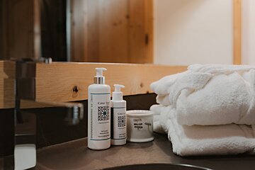 A bathroom counter with bottles of cote sauvage on it