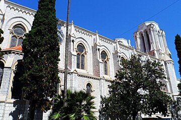 a stone building with arched stained glass windows