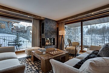A living room with a fireplace and a chess board