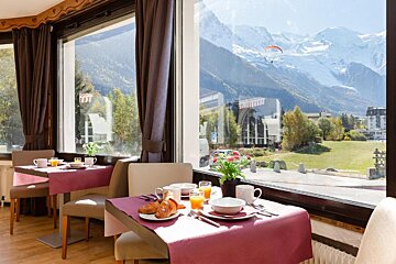 A dining room with a view of the mountains