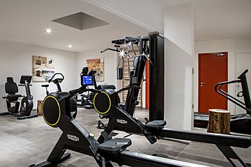 A gym with a machine that says technogym on it