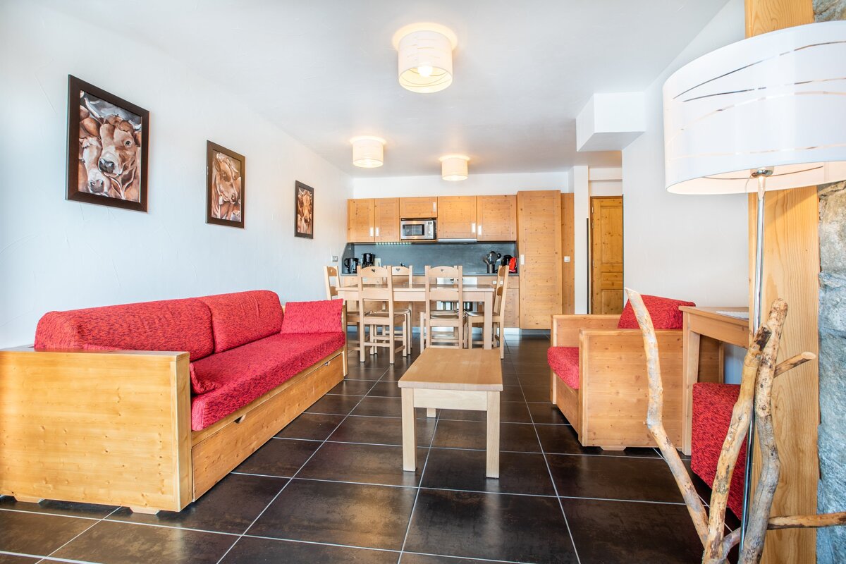 A living room with a couch a chair and a table