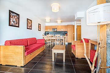 A living room with a couch a chair and a table