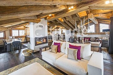 A living room with a white couch and a fireplace