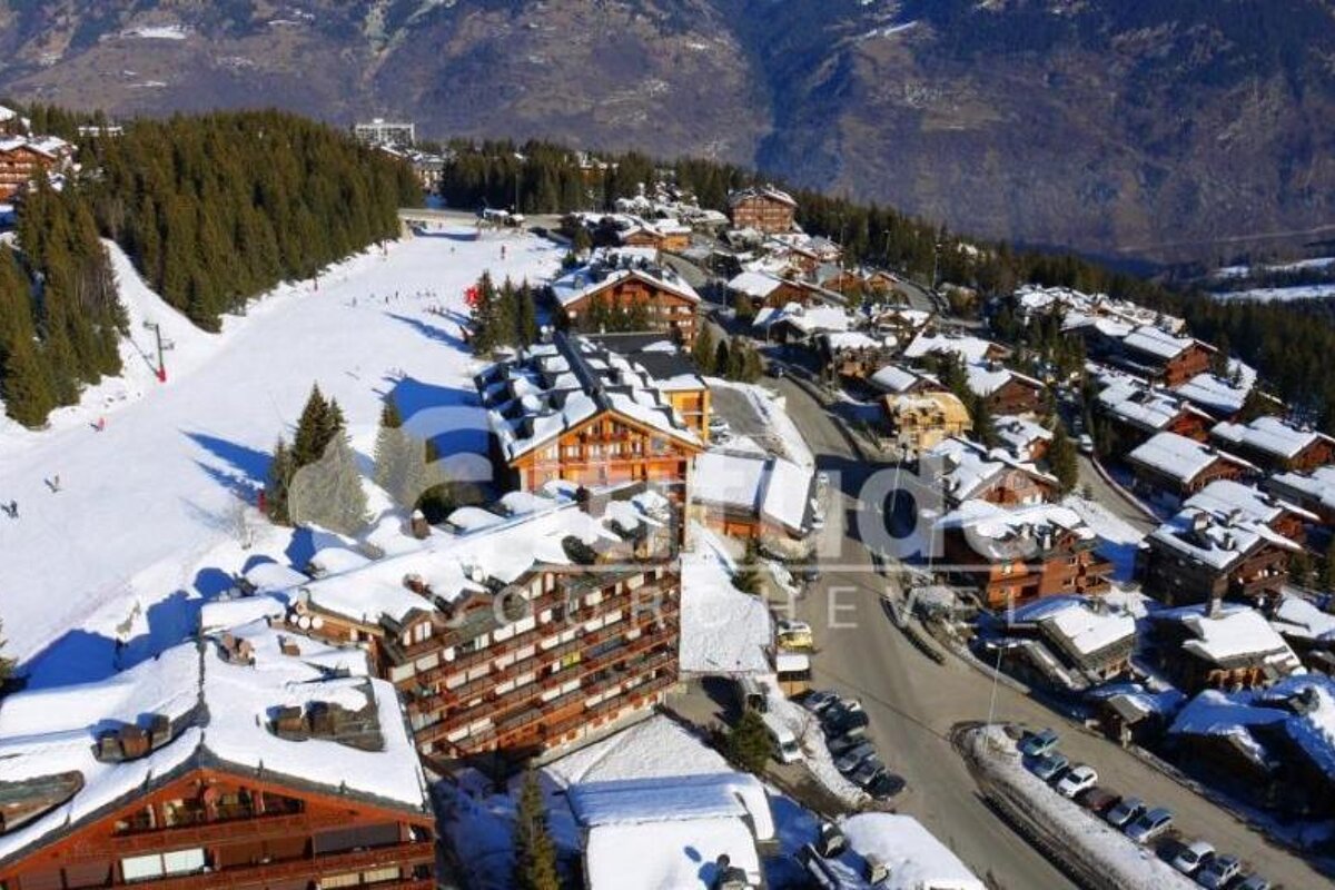 An aerial view of a snowy ski resort with the word studios visible