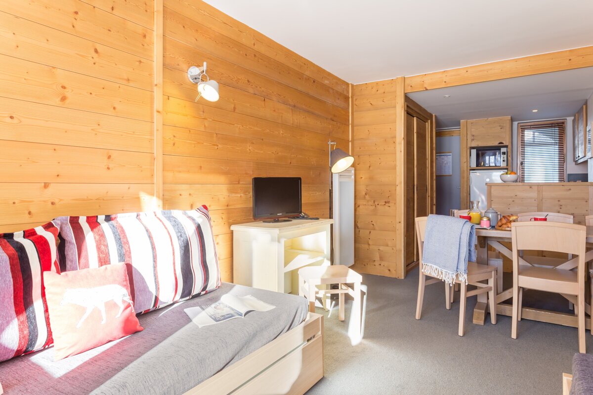 A living room with a couch and a table and chairs