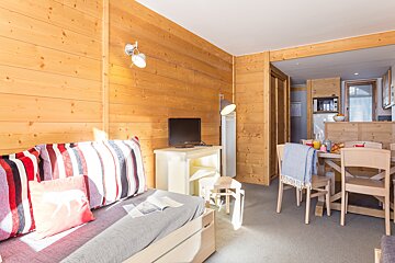 A living room with a couch and a table and chairs