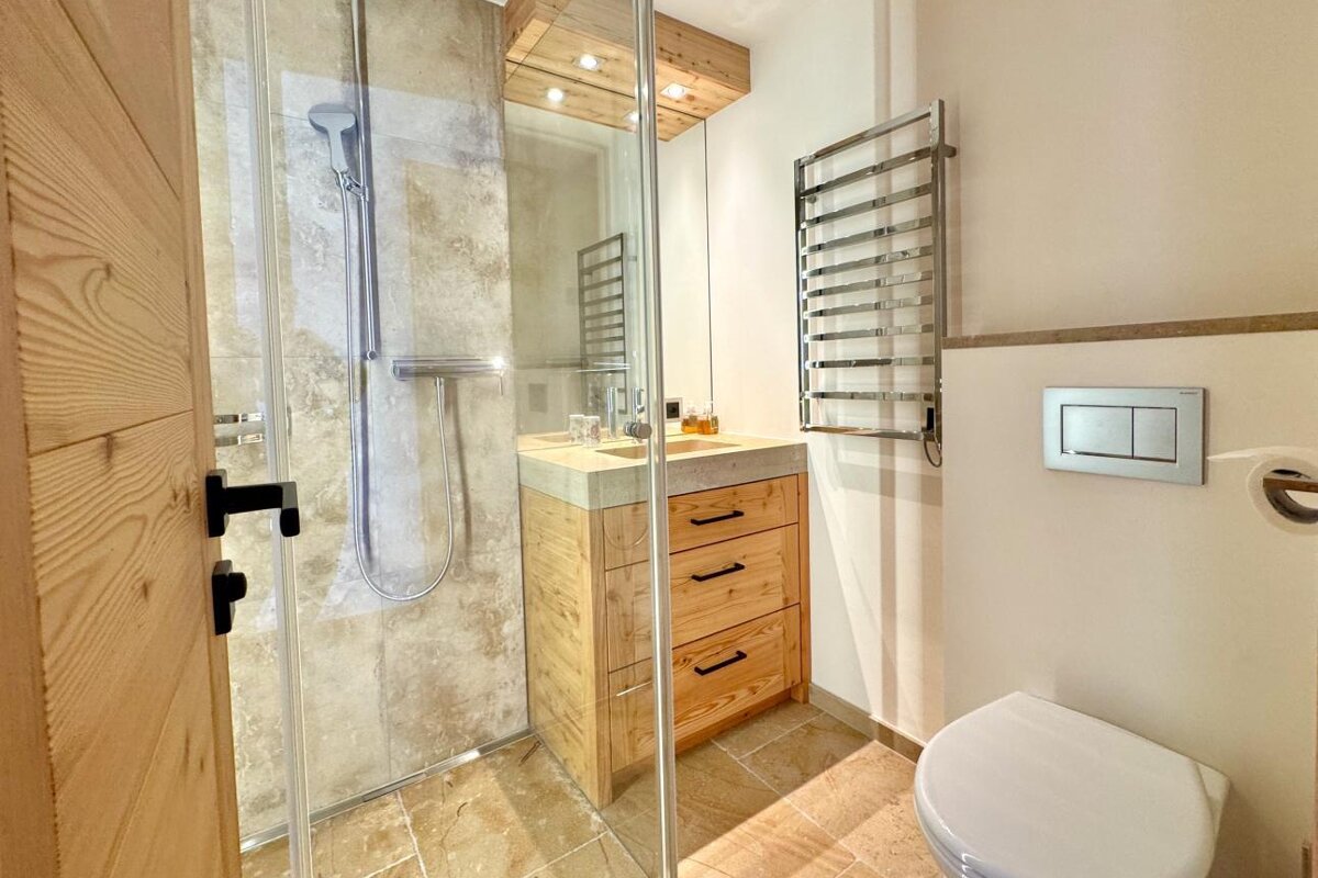 A bathroom with a toilet a sink and a shower